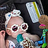 Danaerys joined the competition — help win amazing prizes! baby, car_seat, sunglasses, headband, pacifier, plush_toy, giraffe_toy, monkey_toy, child, infant, cute, accessory, polka_dot, seatbelt, soft_toy, clothing, indoor, comfort, relaxed, baby_fashion