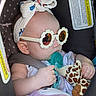 Danaerys joined the competition — help win amazing prizes! baby, car_seat, sunglasses, headband, pacifier, toy, giraffe, plush_toy, infant, child, cute, fashion, accessory, seatbelt, closeup, portrait, indoor, comfort, relaxation, adorable