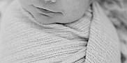 River is registered to the contest to win money with this photo: baby, black_and_white, blanket, close_up, cozy, cute, face, head, indoors, infant, newborn, newborn_baby, peaceful, person, portrait, resting, sleeping, soft_texture, swaddled, wrapped