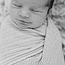 newborn, baby, infant, sleeping, wrapped, blanket, portrait, black_and_white, soft_texture, peaceful, close_up, face, head, swaddled, cute, resting, cozy, newborn_baby, person, indoors