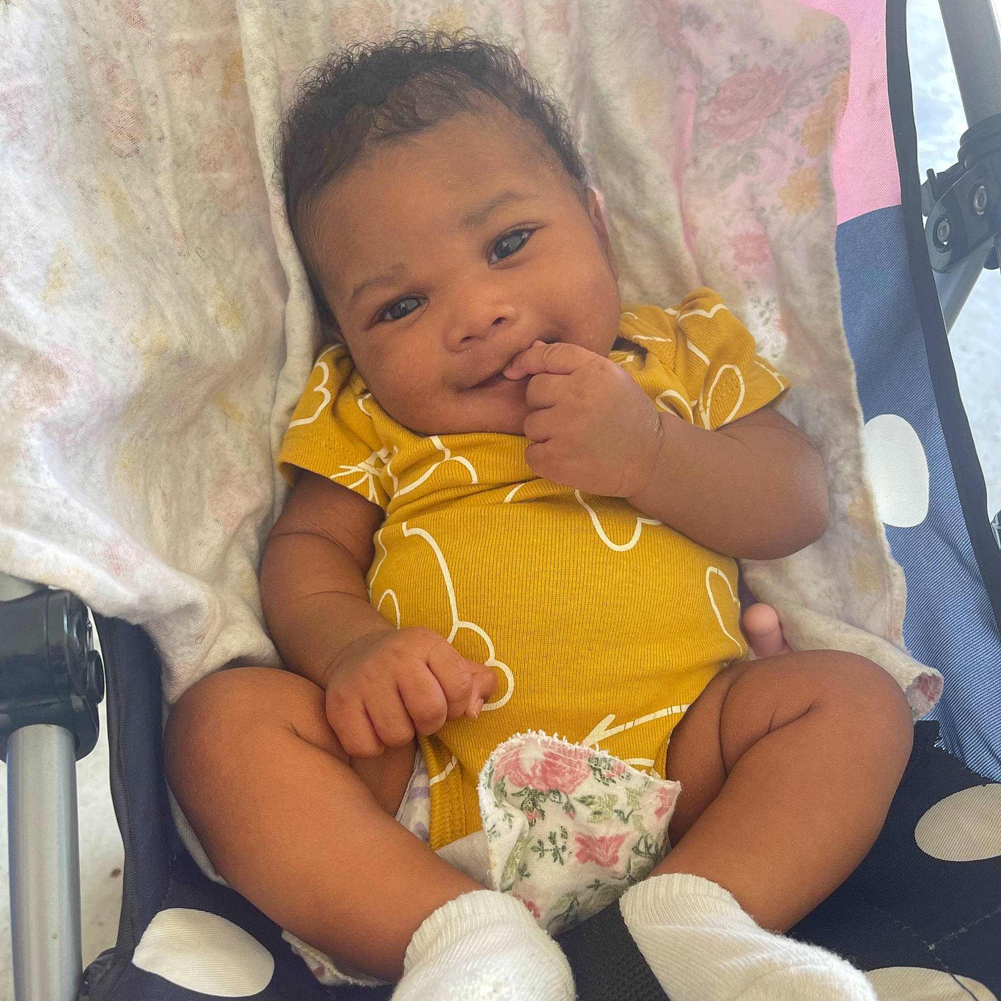 Jaylani is registered to the contest to win money with this photo: arm, baby, baby_toddler_clothing, cheek, comfort, finger, hand, happy, head, iris, lap, leg, mouth, nail, nose, person, skin, textile, thigh, thumb