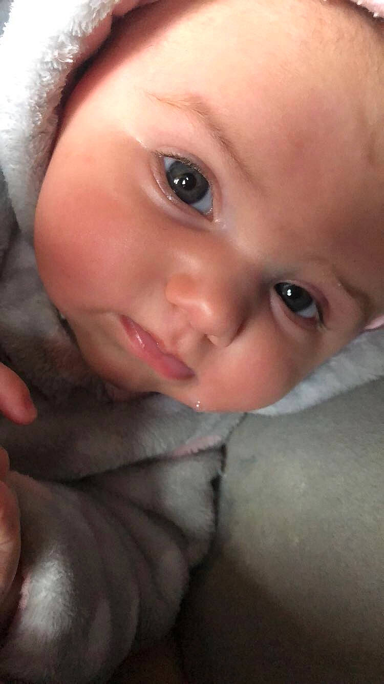 Lainey is registered to the contest to win money with this photo: baby, cheek, child, chin, close_up, eye, eyebrow, eyelash, face, finger, forehead, hand, head, iris, lip, mouth, nose, organ, person, skin