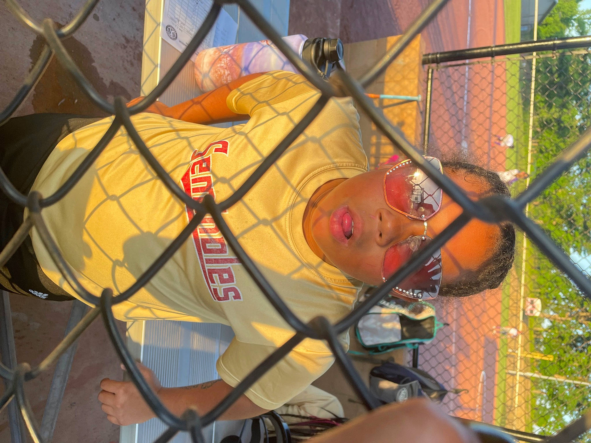 Katrina is registered to the contest to win money with this photo: art, circle, city, fun, grass, hat, headwear, leisure, mesh, metal, natural_environment, net, pattern, person, plant, recreation, tree, visual_arts, wire, wire_fencing