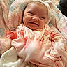 Selena joined the competition — help win amazing prizes! baby, infant, smile, blanket, pacifier, onesie, pink, flamingo, clothing, cute, happy, face, child, newborn, soft, cozy, portrait, indoor, person, babywear