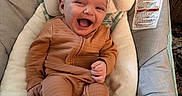 Selena is registered to the contest to win money with this photo: baby, infant, smiling, happy, cozy, pajamas, baby_seat, cushion, face, child, comfort, indoor, cute, joyful, head_support, foot, hand, skin, person, young