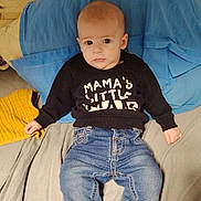 Leo participe au concours pour gagner de l'argent avec cette photo : baby, infant, child, person, clothing, sweatshirt, jeans, socks, bed, pillow, blue_pillow, yellow_towel, indoor, portrait, cute, lying_down, face, expression, casual, young_child