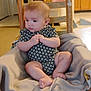 baby, child, infant, wooden_chair, blanket, onesie, floral_pattern, indoor, carpet, furniture, home, person, cute, sitting, hands, feet, expression, room, mirror, kitchen
