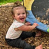 barefoot, black_pants, child, clothing, colorful, face, hair, happy, laughing, outdoor, play, playground, ponytail, portrait, sitting, smiling, summer, toddler, trampoline, wood_chips