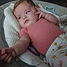 baby, infant, child, pink_shirt, blanket, toy, cushion, face, hand, indoor, comfort, sleepy, cute, young_child, clothing, lying_down, soft_toys, home, portrait, relaxed