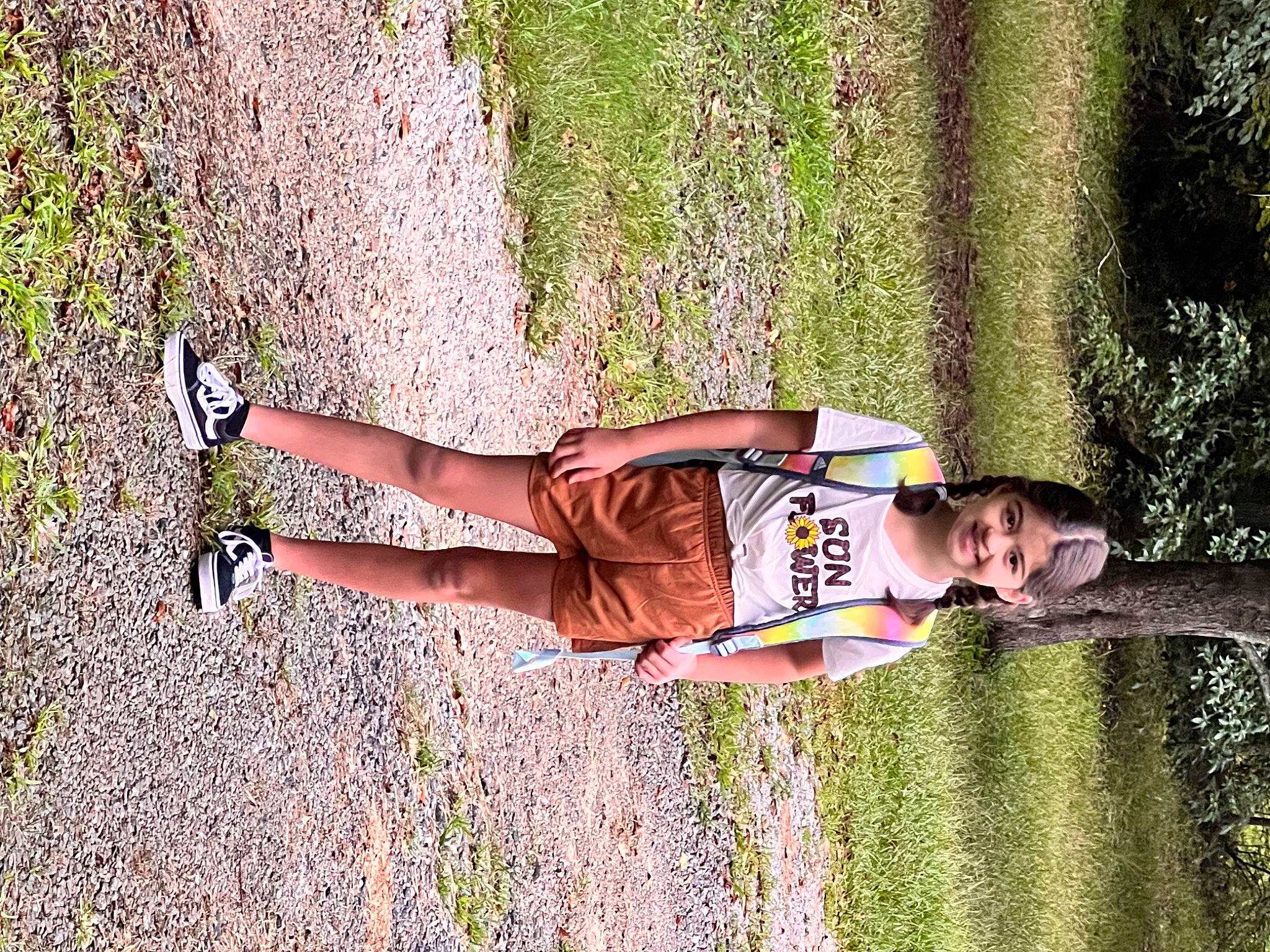 Madeline is registered to the contest to win money with this photo: elbow, fun, grass, grass_family, hand, happy, human_leg, joint, joy, knee, leg, leisure, people_in_nature, person, plant, recreation, shorts, sunlight, thigh, tree