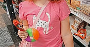 Luna joined the competition — help win amazing prizes! child, girl, toddler, red_hair, smiling, portrait, grocery_store, shopping, snacks, food_aisle, toy, colorful_ball, pink_clothing, skirt, sandals, shopping_cart, shelves, store, handwritten_note, indoors