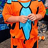 child, boy, smiling, portrait, costume, orange_clothing, blue_clothing, superhero, standing, indoors, bedroom, toys, playroom, carpet, short_hair, happy, full_body, colorful, casual, photography
