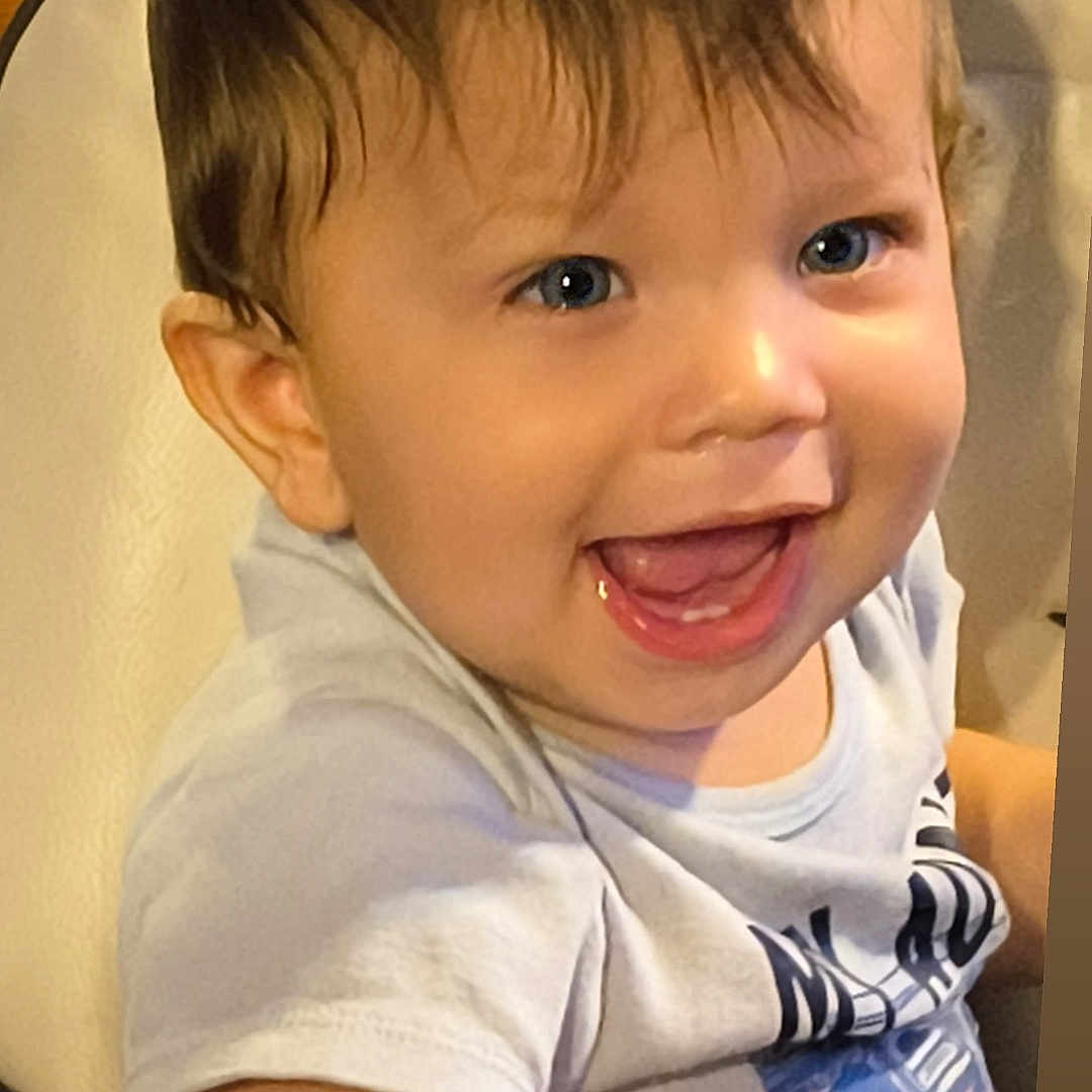 Matthew is registered to the contest to win money with this photo: child, toddler, smiling, happy, blue_eyes, short_hair, sitting, shirt, indoor, cute, baby, face, person, joyful, young_child, infant, portrait, human, childhood, expression