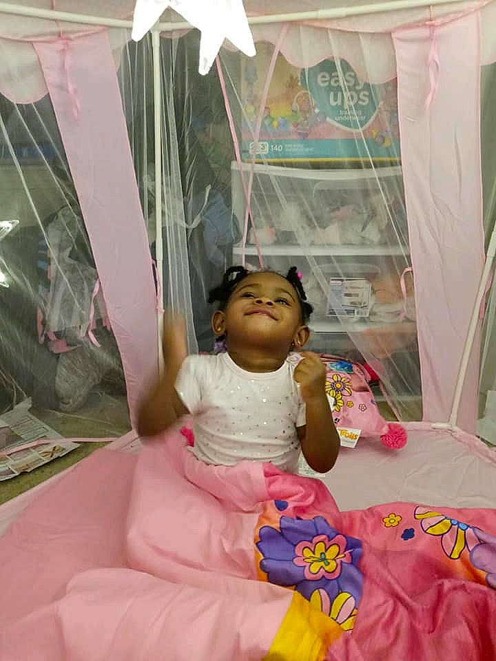 Brazil is registered to the contest to win money with this photo: baby_products, child, dress, event, fashion_accessory, fun, happy, leisure, linens, magenta, peach, person, pink, plastic, recreation, room, sitting, tent, textile, toddler