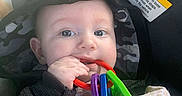 Zauntee Sebastian is registered to the contest to win money with this photo: baby, child, hoodie, toy, colorful, plastic, hand, blanket, car_seat, warning_label, face, eyes, mouth, clothing, infant, cute, indoor, seat, person, closeup