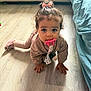 Arya participe au concours pour gagner de l'argent avec cette photo : toddler, child, pacifier, crawling, curly_hair, bow, pajamas, floor, wooden_floor, indoors, cozy, pink, toy, blanket, couch, hand, feet, cute, young_child, home