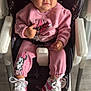 toddler, child, pink_clothing, headband, flower, high_chair, sneakers, thumbs_up, smiling, indoor, floor, person, cute, baby, mickey_mouse, cartoon_character, footwear, seat_belt, happy, portrait