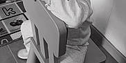 Lonie participe au concours pour gagner de l'argent avec cette photo : child, smiling, chair, indoor, playmat, toy, sneakers, cute, portrait, happy, young, person, floor, clothing, curly_hair, monochrome, toddler, playroom, sitting, cozy