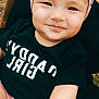 baby, black_shirt, casual, child, clothing, cute, face, family, girl, happy, headband, infant, nature, outdoor, person, pink_shorts, portrait, sitting, skin, smile