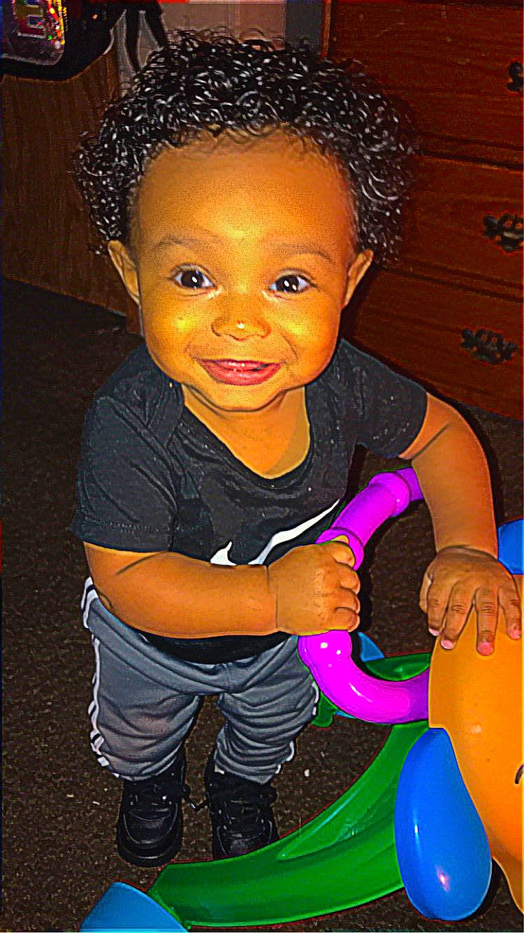 Damari is registered to the contest to win money with this photo: afro, baby_playing_with_toys, baby_toddler_clothing, cheek, child, eye, flash_photography, fun, happy, jheri_curl, joy, lip, magenta, nose, organ, person, pink, skin, smile, standing