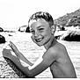 Jules participe au concours pour gagner de l'argent avec cette photo : boy, child, smile, water, rock, outdoor, beach, portrait, black_and_white, happy, wet_hair, nature, sunlight, shoreline, youth, summer, playful, bare_chest, scenic, leisure