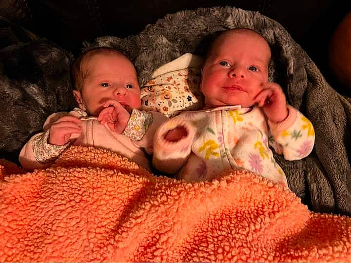 Charlotte And Addison is registered to the contest to win money with this photo: baby, baby_toddler_clothing, cheek, child, comfort, eye, facial_expression, finger, hand, happy, iris, lip, mouth, nose, orange, organ, person, pink, skin, toddler