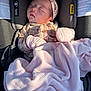 baby, blanket, car_seat, child, clothing, cozy, headband, indoors, infant, mittens, newborn, peaceful, pink, portrait, protection, resting, seat, sleeping, soft, sunlight