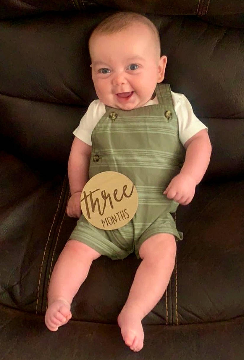 Evan is registered to the contest to win money with this photo: baby, baby_toddler_clothing, cheek, comfort, couch, eye, face, finger, flash_photography, human_body, joint, joy, knee, leg, person, skin, sleeve, smile, stomach, thigh