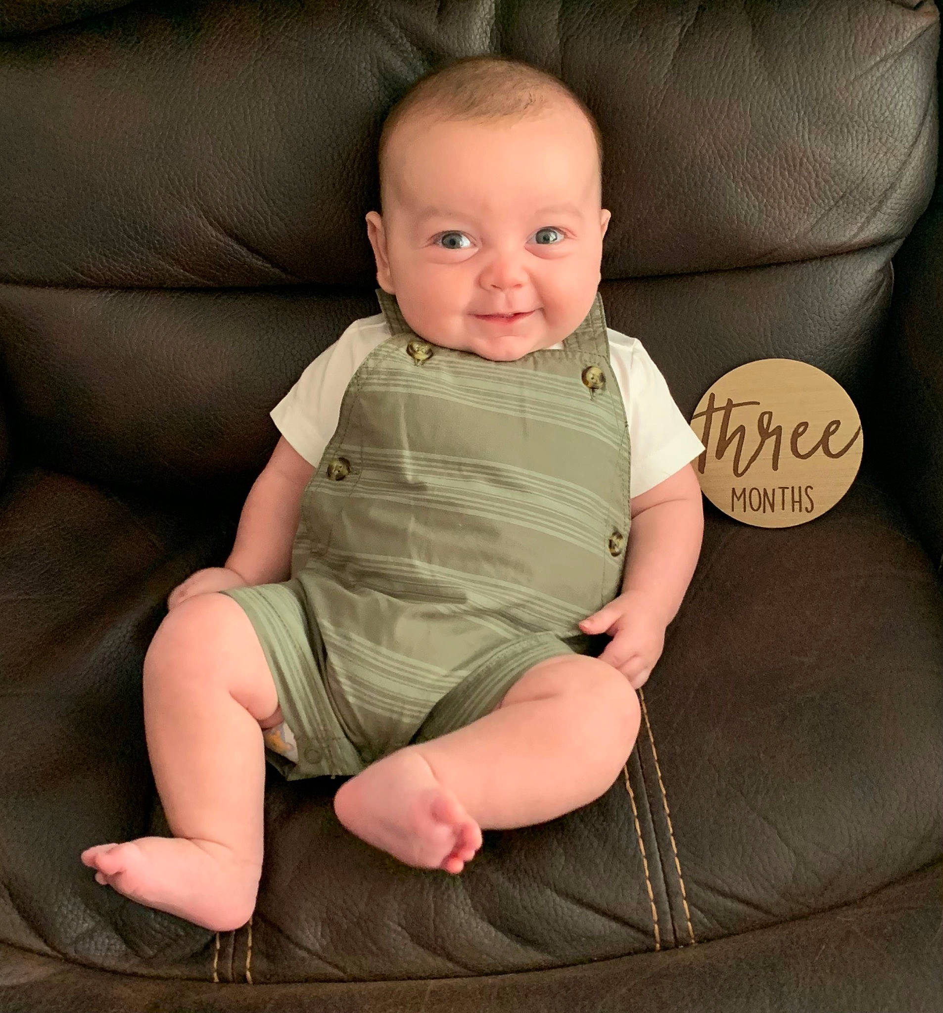 Evan is registered to the contest to win money with this photo: baby, baby_toddler_clothing, barefoot, cheek, child, comfort, couch, elbow, eye, finger, foot, human_body, human_leg, joy, knee, lap, person, sitting, sleeve, smile