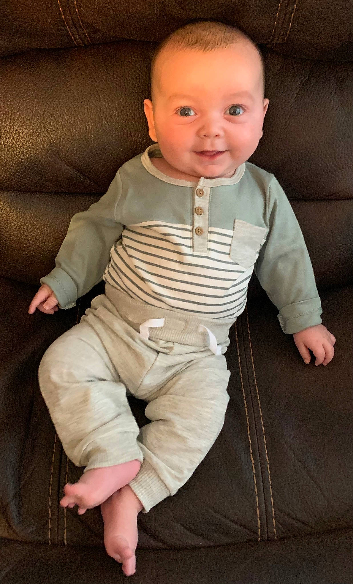 Evan is registered to the contest to win money with this photo: baby, baby_toddler_clothing, cheek, child, collar, comfort, dress_shirt, eye, face, flash_photography, head, human_leg, joy, lip, nose, person, sitting, skin, sleeve, smile