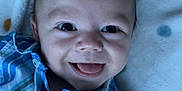 Carter joined the competition — help win amazing prizes! baby, smiling, tongue_out, blue_shirt, plaid, blanket, polka_dot, infant, face, cute, happy, closeup, portrait, child, clothing, lying_down, soft_texture, indoor, person, skin