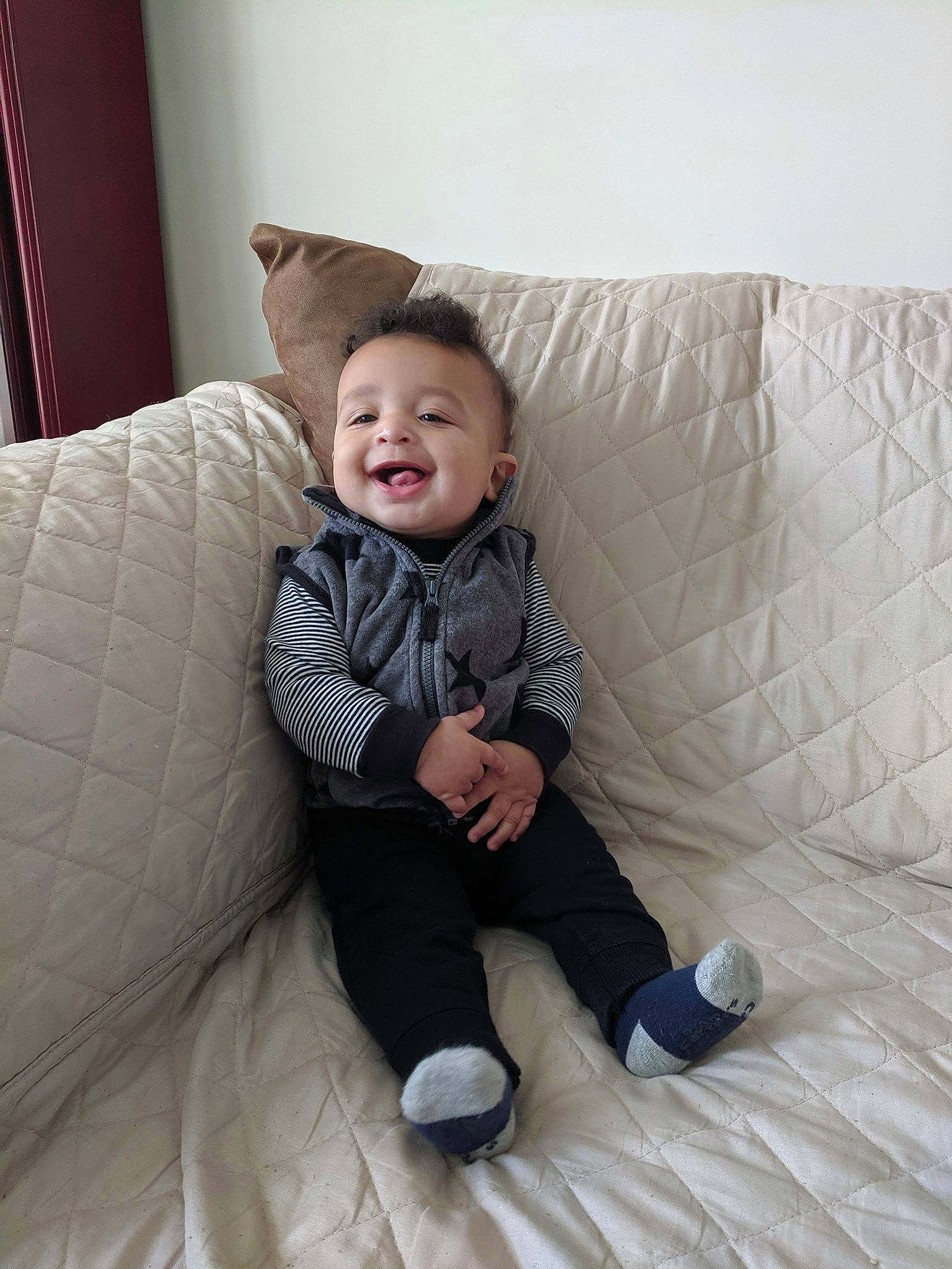 Zaylin is registered to the contest to win money with this photo: baby, bedding, child, comfort, furniture, leg, person, room, sitting, skin, smile, toddler