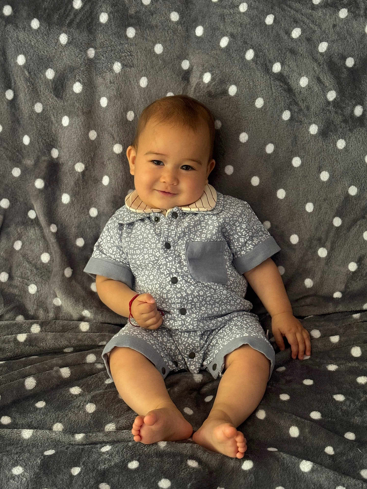 Raiden joined the competition — help win amazing prizes! baby, child, smiling, polka_dot, blanket, gray, clothing, romper, sitting, feet, hand, face, cute, indoor, portrait, comfortable, happy, young, infant, patterned