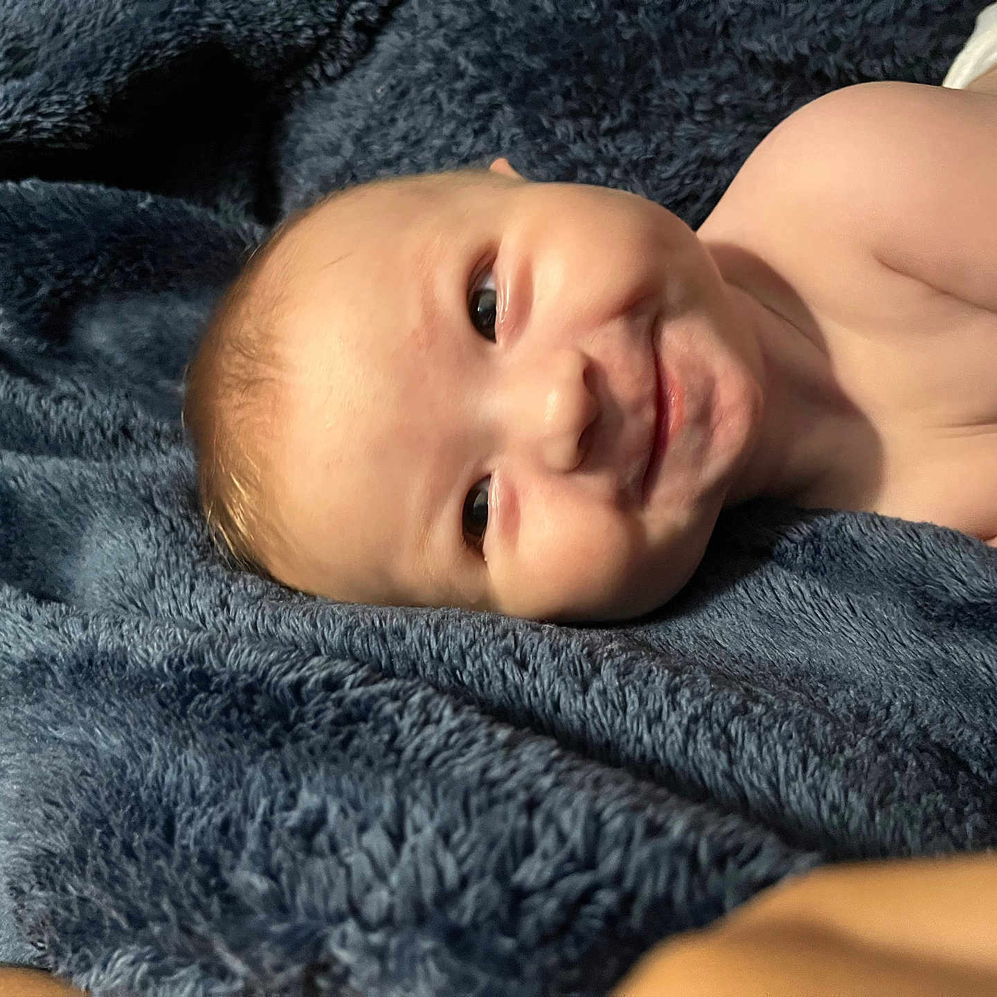 Colton is registered to the contest to win money with this photo: baby, babylaughing, blanket, face, happy, head, newborn, person, photography, portrait, quilt, smile, towel