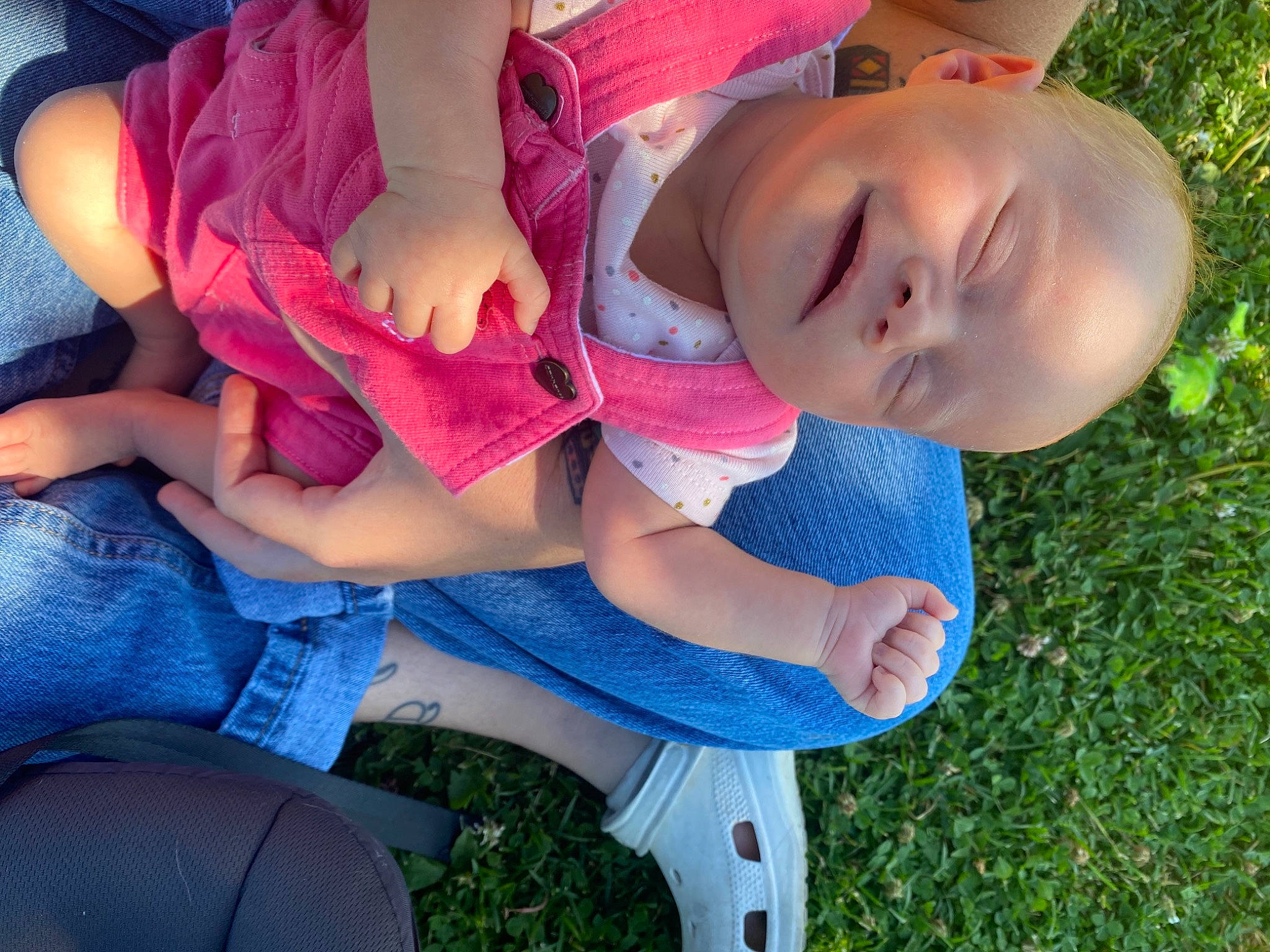 Indie is registered to the contest to win money with this photo: baby_toddler_clothing, child, clothing, electric_blue, eye, fun, grass, happy, human_leg, knee, lap, leg, leisure, mouth, person, pink, plant, summer, thigh, toddler