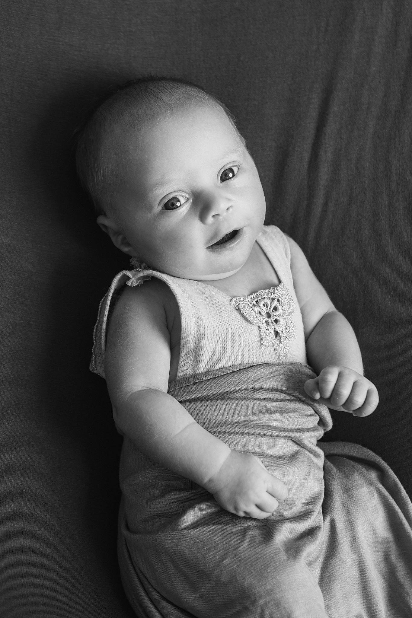 Indie is registered to the contest to win money with this photo: arm, baby, baby_toddler_clothing, cheek, chin, eye, flash_photography, grey, happy, head, human_body, iris, lip, mammal, neck, person, shoulder, skin, sleeve, smile