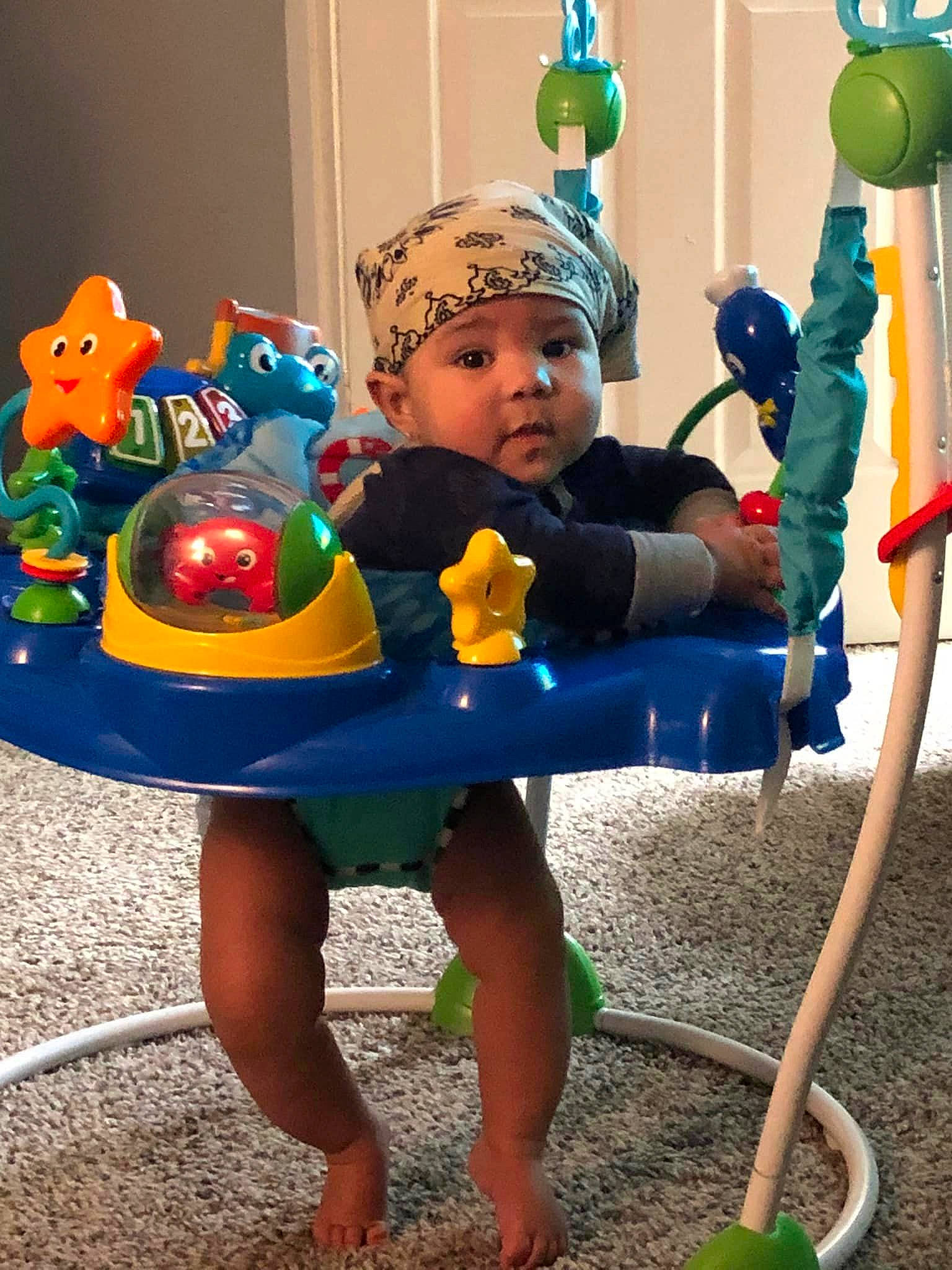 Du'Saan Duncan is registered to the contest to win money with this photo: baby_toddler_clothing, baby_toys, child, city, electric_blue, fun, green, happy, headwear, human_settlement, leisure, outdoor_play_equipment, party_supply, person, plastic, play, public_space, shorts, sitting, toddler