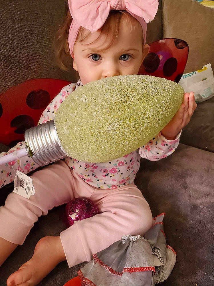 Zailey is registered to the contest to win money with this photo: baby_toddler_clothing, child, comfort_food, cuisine, dish, food, fun, happy, helmet, human_body, ingredient, junk_food, people_in_nature, person, pink, popcorn, stuffed_toy, sweetness, toddler, toy