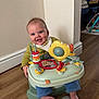 Oliver joined the competition — help win amazing prizes! baby, infant, smiling, child, toy, activity_seat, floor, wooden_floor, indoor, playmat, foot, couch, furniture, clothing, bib, happy, person, head, face, home