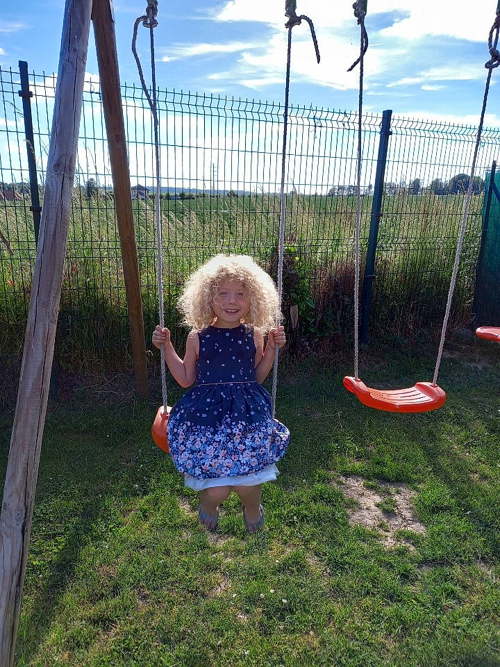 Kalicia a rejoint le concours — aidez-le/la à gagner de superbes lots ! baby_toddler_clothing, city, cloud, fun, grass, grass_family, human_settlement, joy, leisure, mesh, nature, outdoor_play_equipment, people_in_nature, person, plant, pole, recreation, sky, swing, toddler