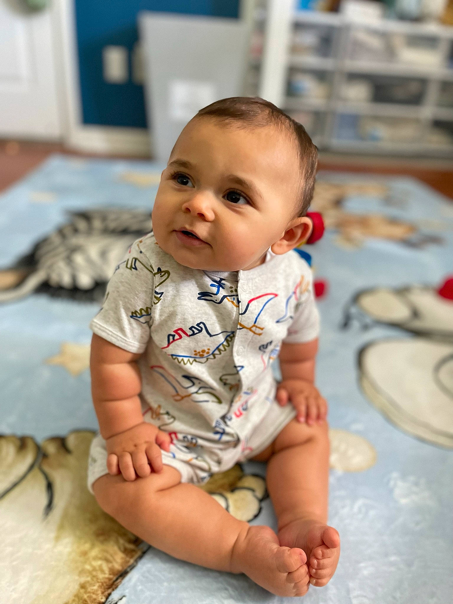 Justice is registered to the contest to win money with this photo: baby, baby_toddler_clothing, cheek, child, comfort, elbow, finger, floor, flooring, fun, happy, iris, nose, person, sitting, skin, sleeve, smile, t_shirt, toddler