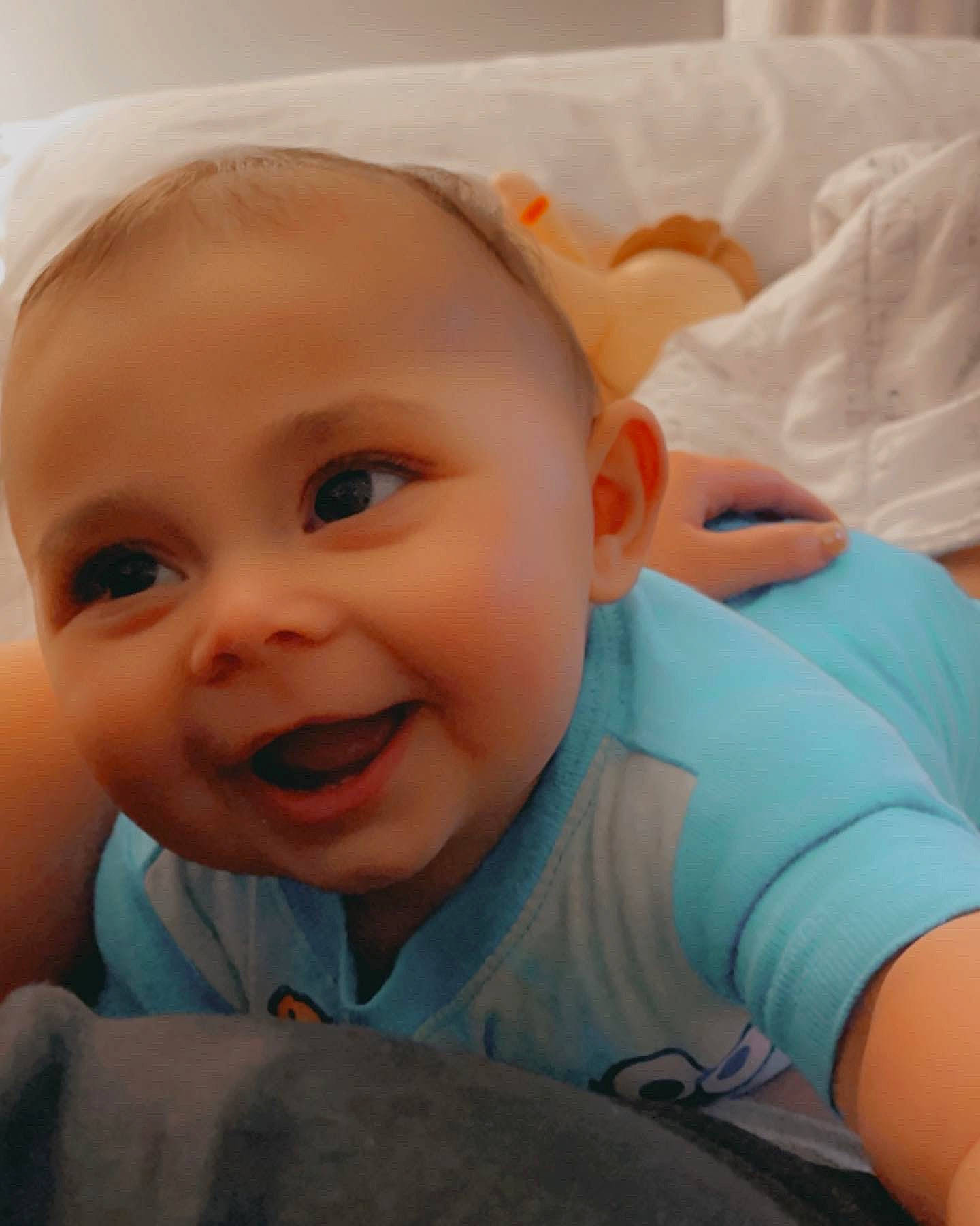 Justice is registered to the contest to win money with this photo: arm, baby, baby_toddler_clothing, cheek, chin, comfort, eye, eyebrow, face, finger, gesture, happy, head, iris, lip, mouth, nose, person, skin, sleeve