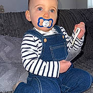 Kassïm participe au concours pour gagner de l'argent avec cette photo : toddler, child, pacifier, striped_clothing, denim_overalls, blue_eyes, thermometer, couch, gray_couch, indoor, kneeling, baby, person, home, soft_furniture, cute, portrait, casual_clothing, small_child, curious