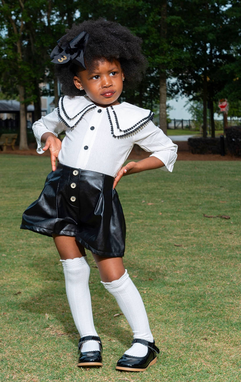 Khloe is registered to the contest to win money with this photo: child, clothing, footwear, knee, person, school_uniform, uniform