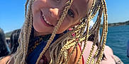 Elaïa a rejoint le concours — aidez-le/la à gagner de superbes lots ! child, smiling, braids, blonde_hair, outdoor, sunny, blue_sky, water, people, portrait, happy, face, arm, colorful_clothing, daylight, playful, holiday, nature, person, closeup
