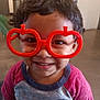 Angel joined the competition — help win amazing prizes! toddler, child, glasses, toy_glasses, smile, happy, indoors, short_hair, red_shirt, blue_shirt, face, portrait, cute, drool, playful, young_child, person, casual_clothing, funny_glasses, cheerful