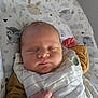Arthur participe au concours pour gagner de l'argent avec cette photo : baby, sleeping, infant, cozy, blanket, patterned_cushion, animal_prints, yellow_clothing, white_clothing, peaceful, closeup, portrait, newborn, child, soft_lighting, resting, cute, indoors, face, fingers