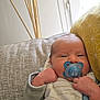 Arthur a rejoint le concours — aidez-le/la à gagner de superbes lots ! baby, newborn, pacifier, blue, couch, pillow, yellow, close_up, infant, hand, face, cute, cozy, indoor, soft_light, pattern, clothing, relaxing, child, resting