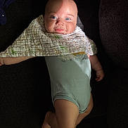 Jaxson joined the competition — help win amazing prizes! baby, infant, smiling, blue_eyes, blanket, onesie, couch, soft_lighting, face, skin, cute, child, lying_down, indoors, comfort, cozy, portrait, small_hands, small_feet, happy