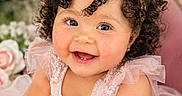 Amaya is registered to the contest to win money with this photo: adorable, baby, bow, celebration, child, chubby_cheeks, closeup, curly_hair, cute, flower_background, happy, headband, indoor, infant, person, pink_dress, portrait, smiling, toddler, tulle